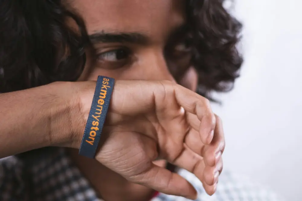 A close up of a person wearing a wristband, illustrating gifts and meaning